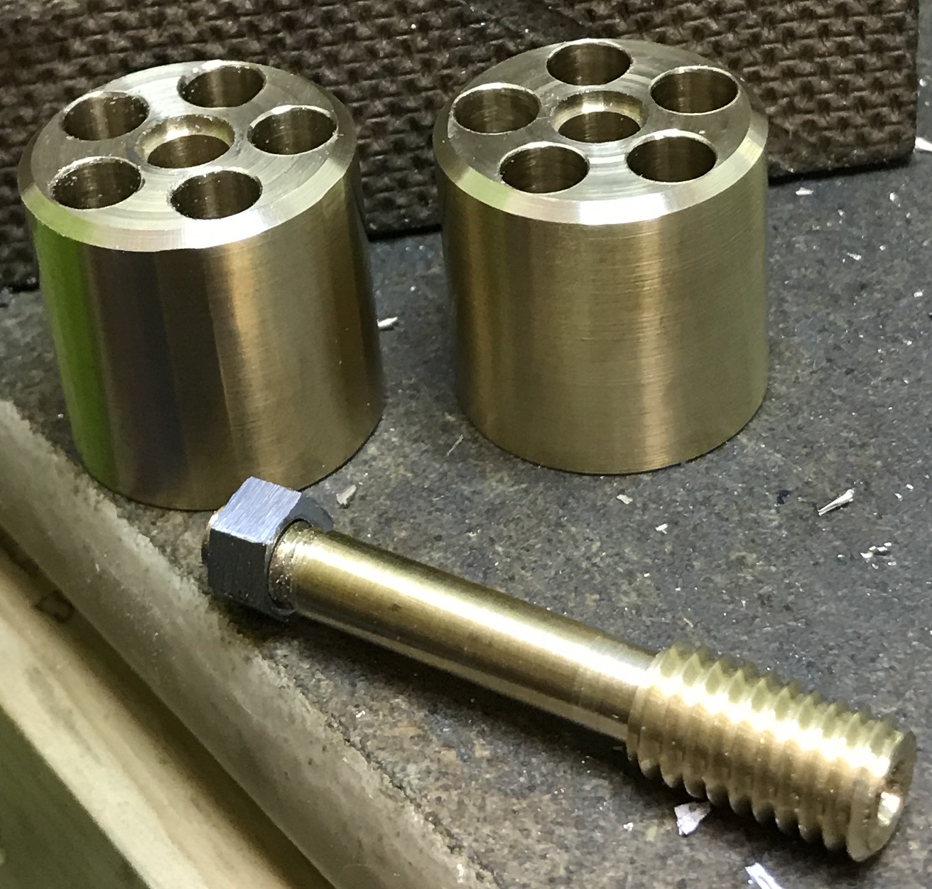 Completed cylinders alongside adapter and nut